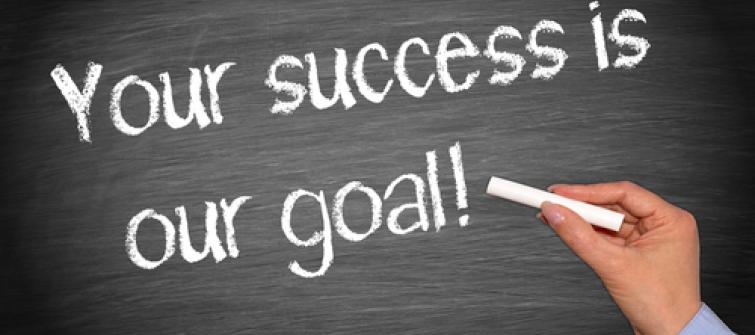 Blackboard with Your success is our goal! Written on it.