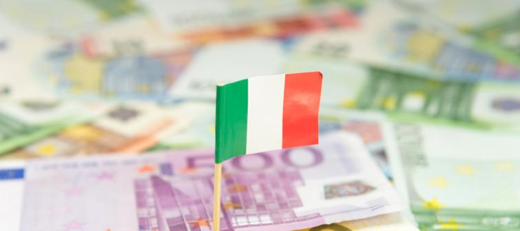 Miniature Italian flag over a pile of Euros.