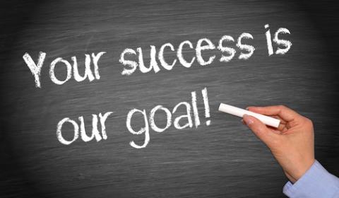 Blackboard with Your success is our goal! Written on it.