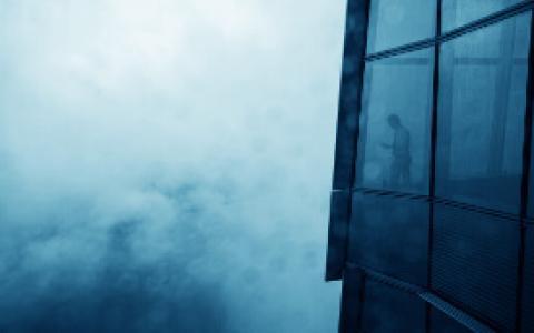 A Building in the Clouds with a Person in the Window