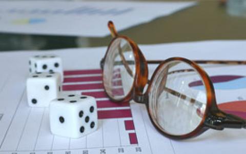 Dice and Glasses on Top of a Graph Print Out