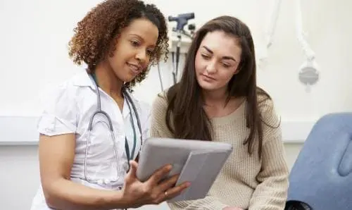Doctor showing patient information on a tablet