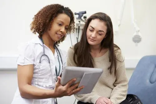 Doctor showing patient information on a tablet
