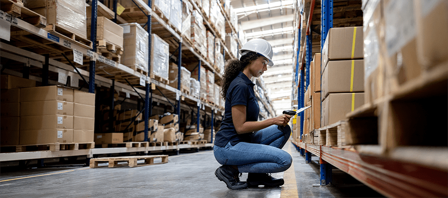woman in stock room scanning items from her inventory list