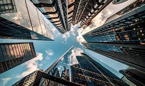 Highly detailed abstract wide angle view up towards the sky in the financial district of London City and its ultra modern contemporary buildings with unique architecture. Shot on Canon EOS R full frame with 10mm wide angle lens. Image is ideal for background.