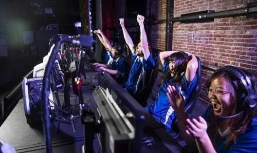 group of gamers celebrating in front of computers