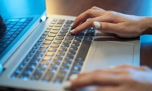 woman typing on a laptop