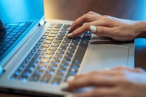 woman typing on a laptop