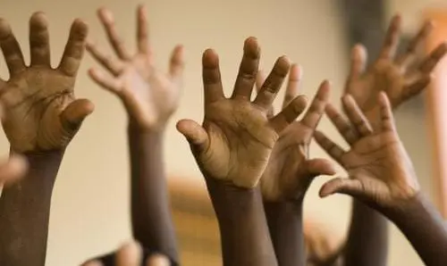 children raising their hands
