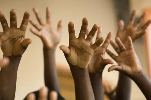 children raising their hands