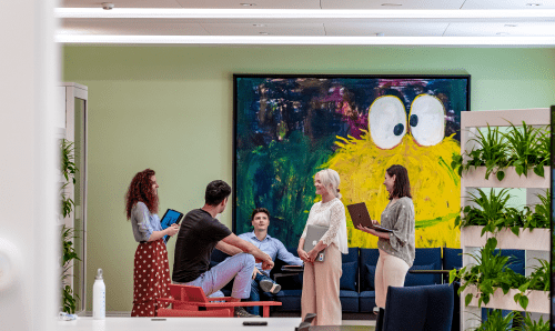 group of people collaborating with laptops and tablets