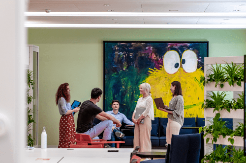 group of people collaborating with laptops and tablets