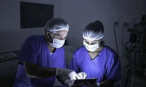 Doctor doing eye surgery of patient in hospital