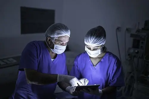 Doctor doing eye surgery of patient in hospital