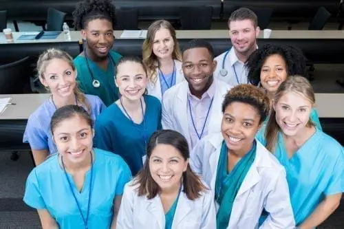 group of medical professionals smiling up at a camera