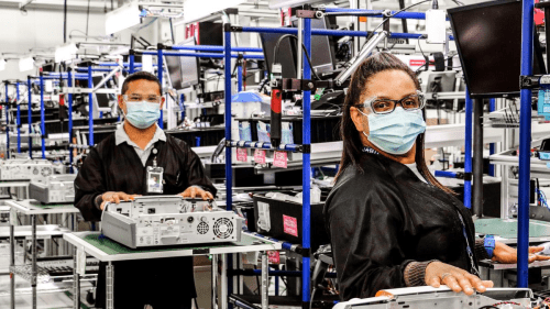 two employees in masks looking at the camera