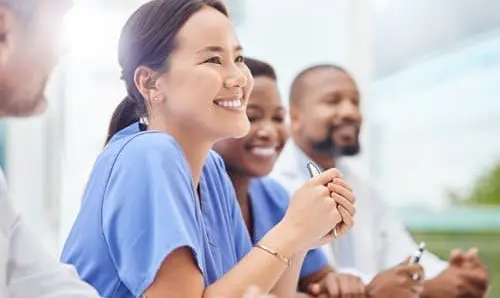 healthcare workers wearing scrubs and smiling