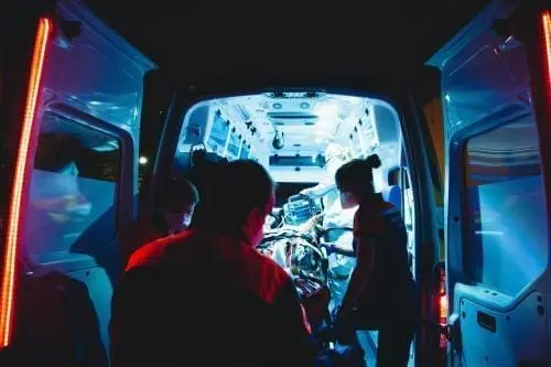 EMTs putting a pateint in an ambulance