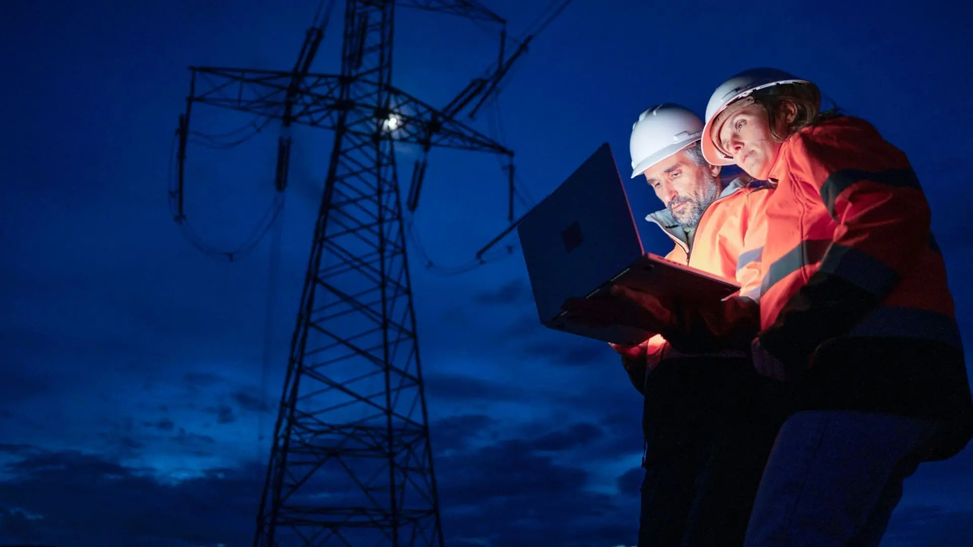utility workers in front of powerline