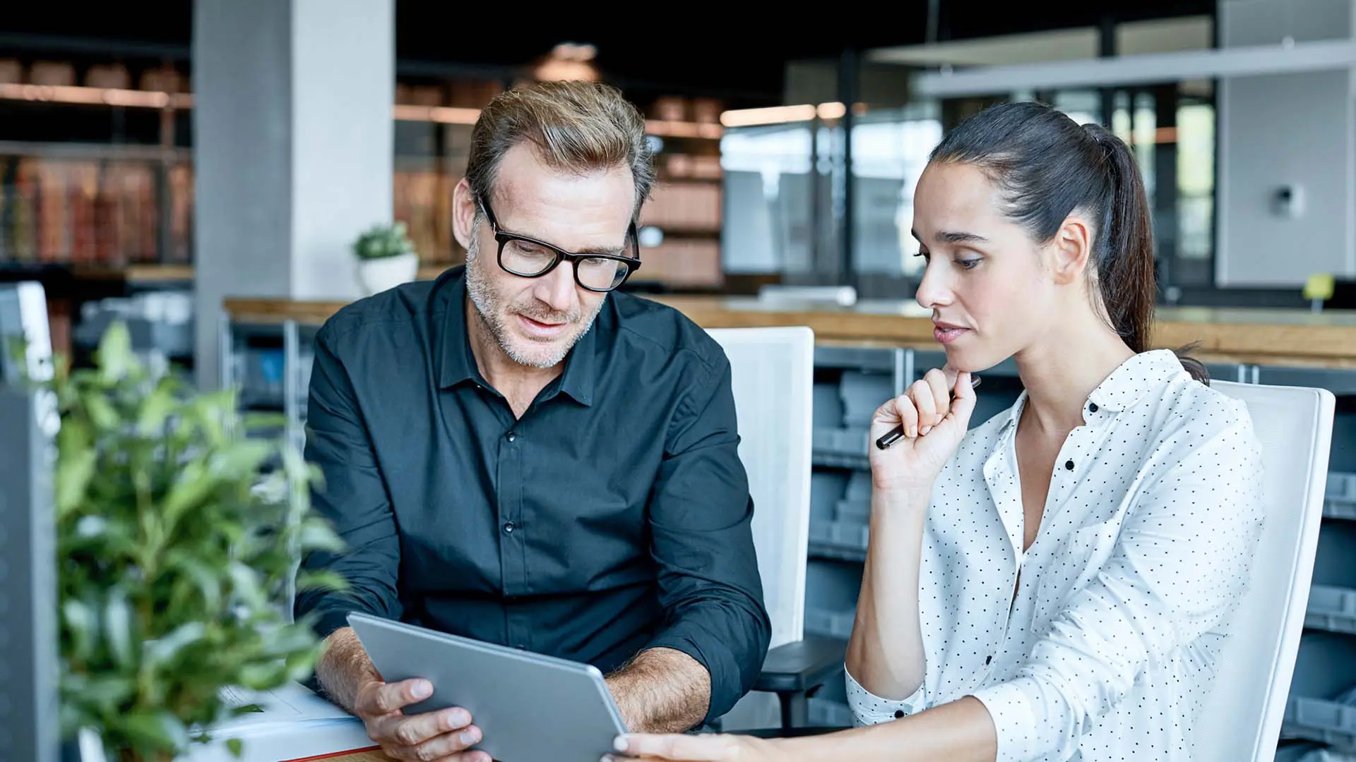 co-workers assessing data together in office