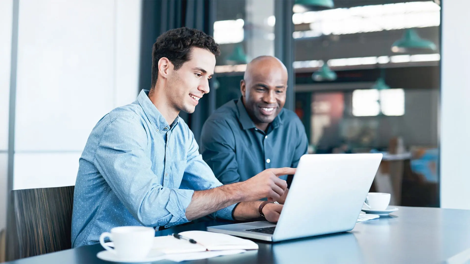 Co-workers in office looking at Coupa platform UI