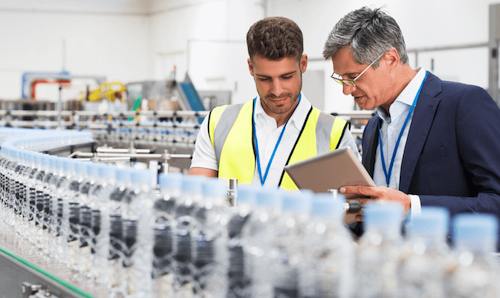 People inspecting an production line of water bottles