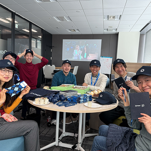 Group photo at a table with Coupa merch