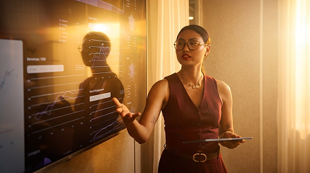 Woman standing in front of a smart board making a presentation
