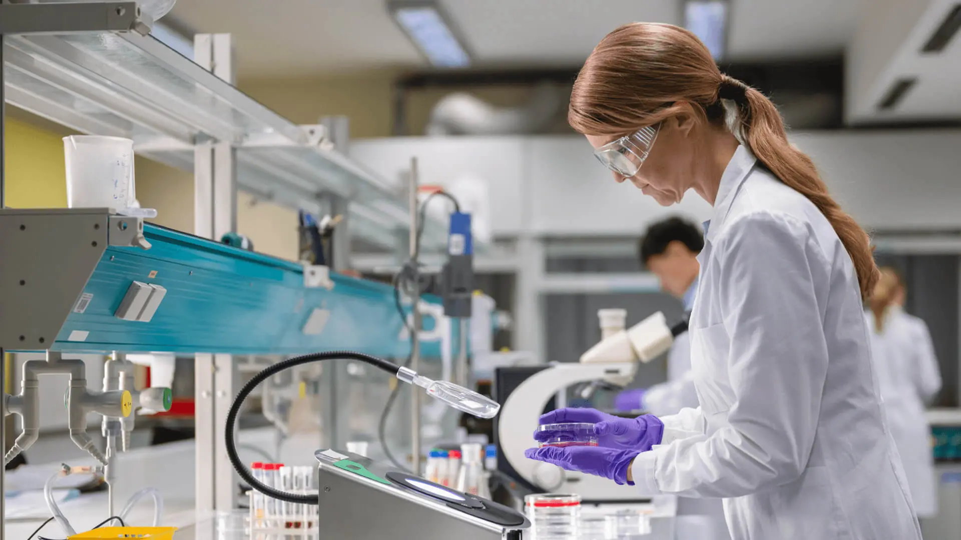 Eurofins Case Study Image of a woman in a lab coat in a lab handling a petri dish