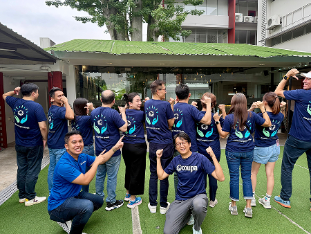Coupa employees wearing matching Global Impact Week t-shirts pose together