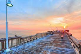 A boardwalk overlooking the ocean at sunset