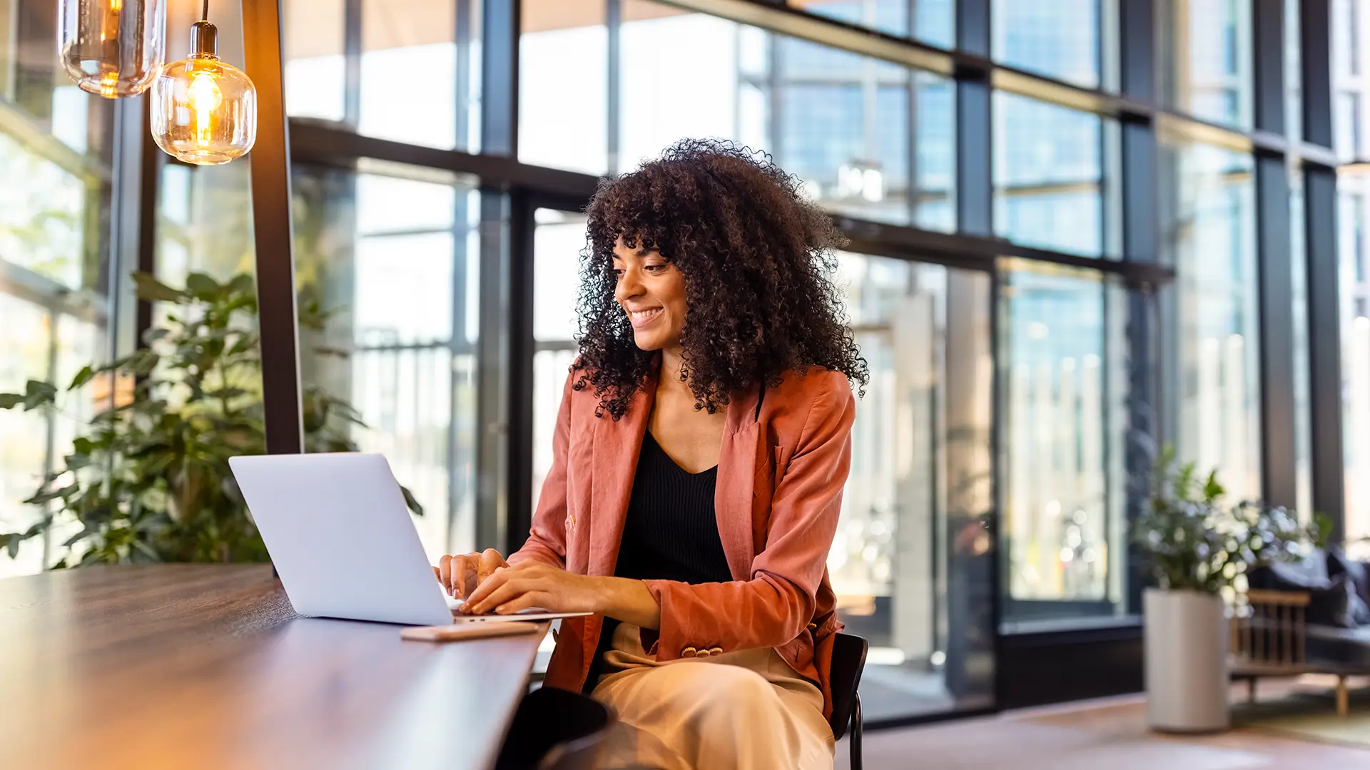 Woman sitting at a desk working on a laptop